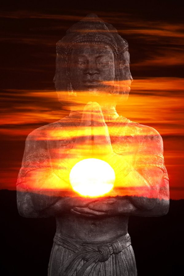 A stone Buddha and a sunset in a single double exposure